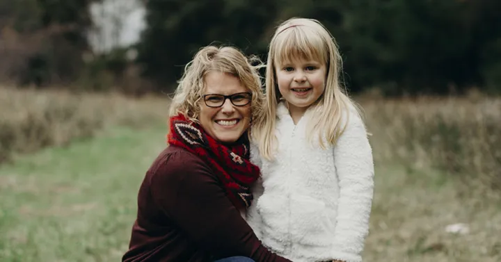 A woman and a young girl in a field