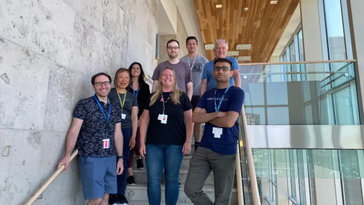 A group of people stand on stairs
