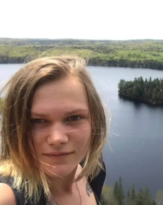 A woman in front of a lake