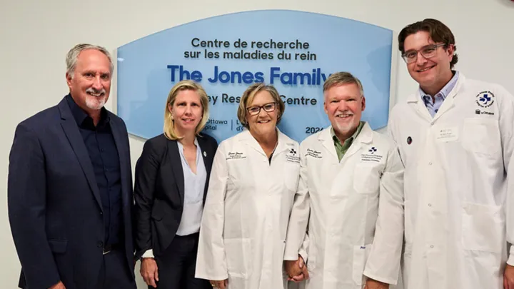 Five people standing in front of a sign for the Jones Family Kidney Research Centre
