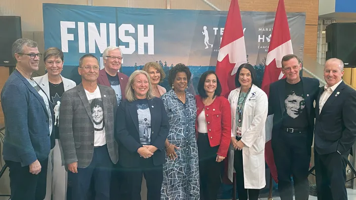 A group of people stand behind a podium
