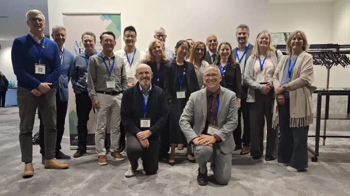 Group of people posing at a conference