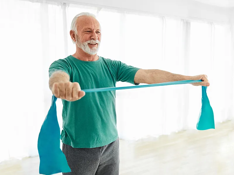 A person stretching an exercise band between their hands