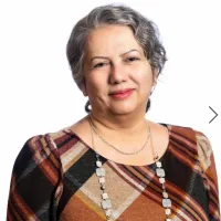 A woman smiles at the camera