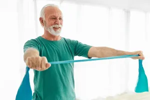 A person stretches an exercise band with their hands