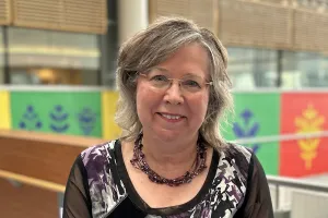 A woman stands in a hospital hallway