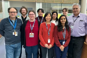 A group of people stand together in a group