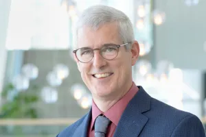 A man smiles at the camera