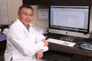 Man sits at a desk with a computer
