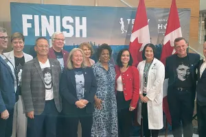 A group of people stand behind a podium