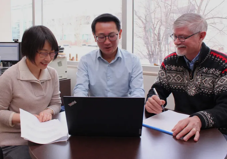 Three MIR researchers during a work meeting.  