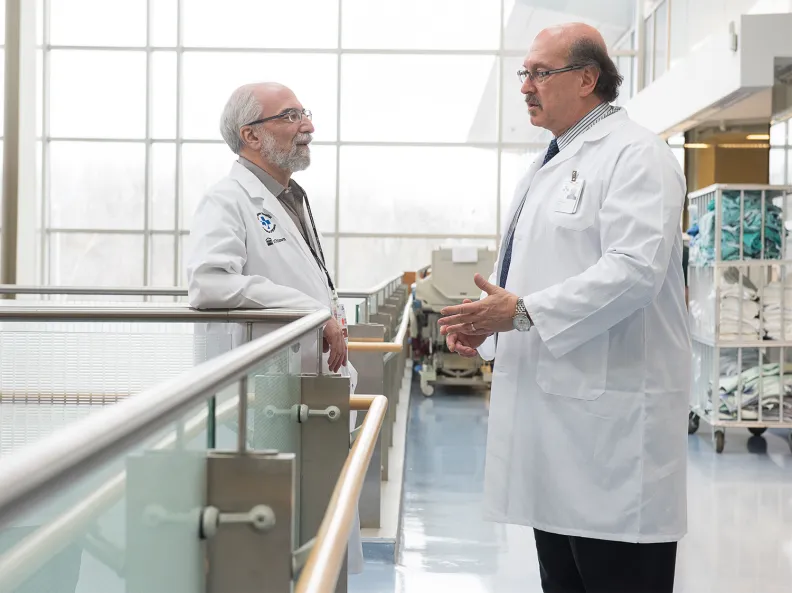 Two doctors talk in a hospital hallway