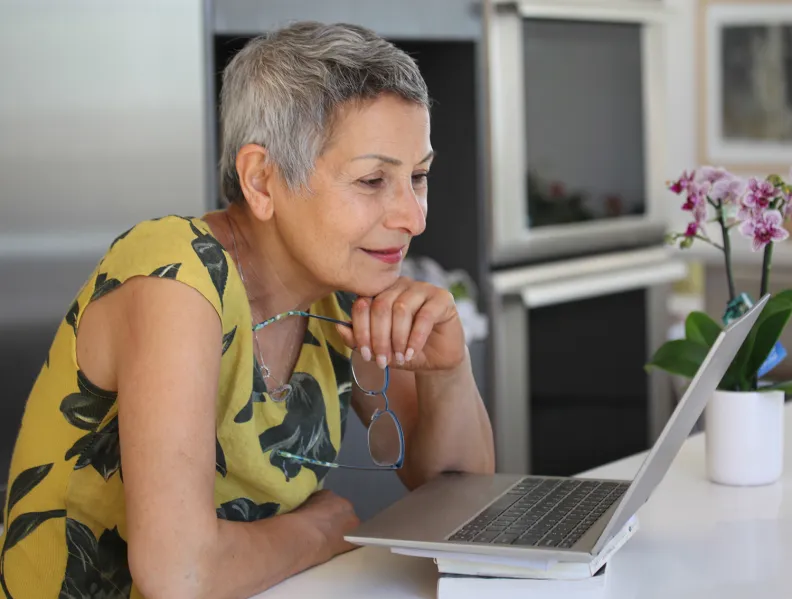 A woman looks at a computer
