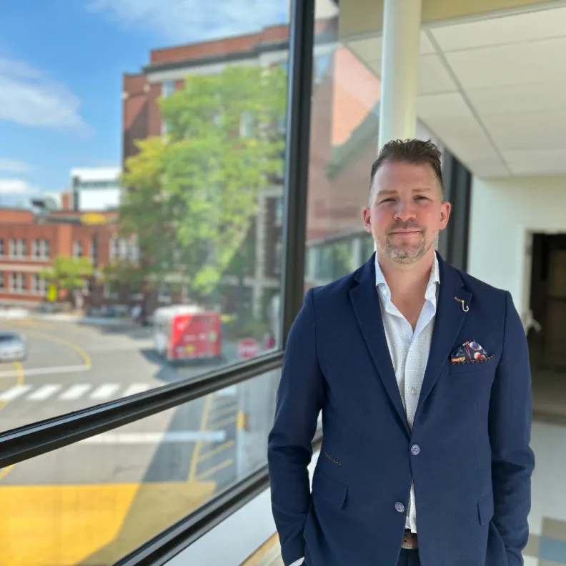 A man stands in the hallway of a hospital 