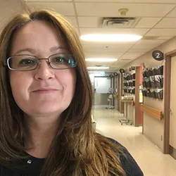 A smiling woman wearing glasses