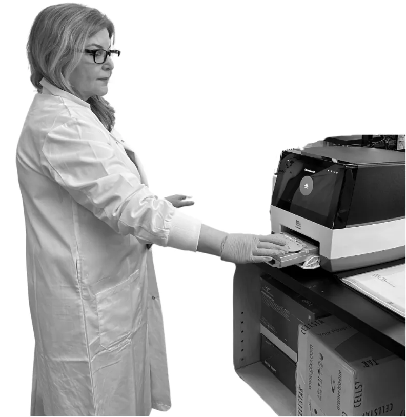 A biomedical technician works with the 10x Genomics Chromium X instrument
