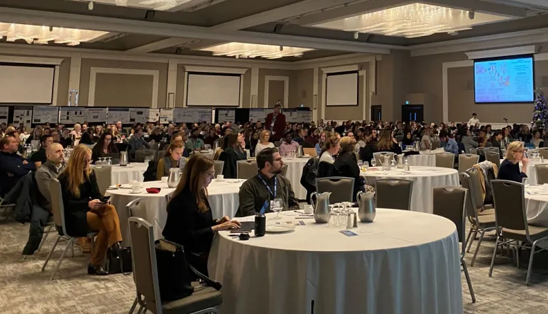 People sitting at tables at a conference