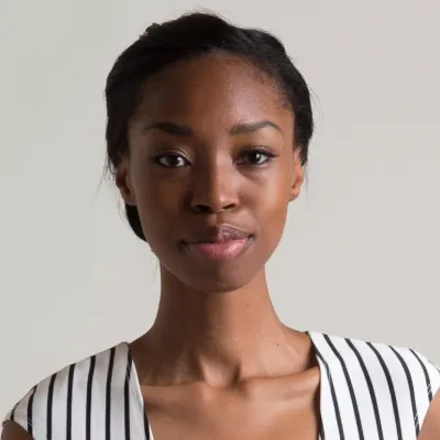 A woman smiles at the camera