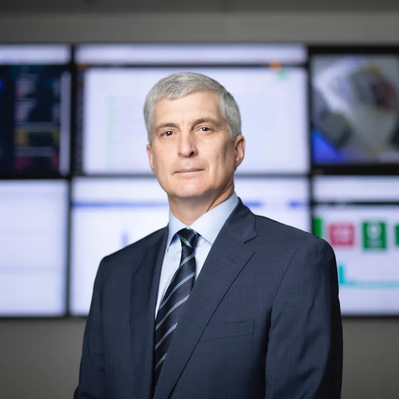 Man in suit looks at camera
