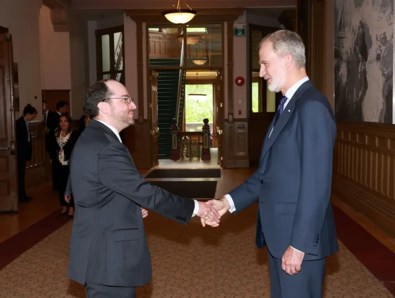 Two men in suits shake hands
