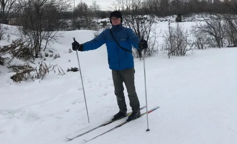A man wearing skies outside during winter